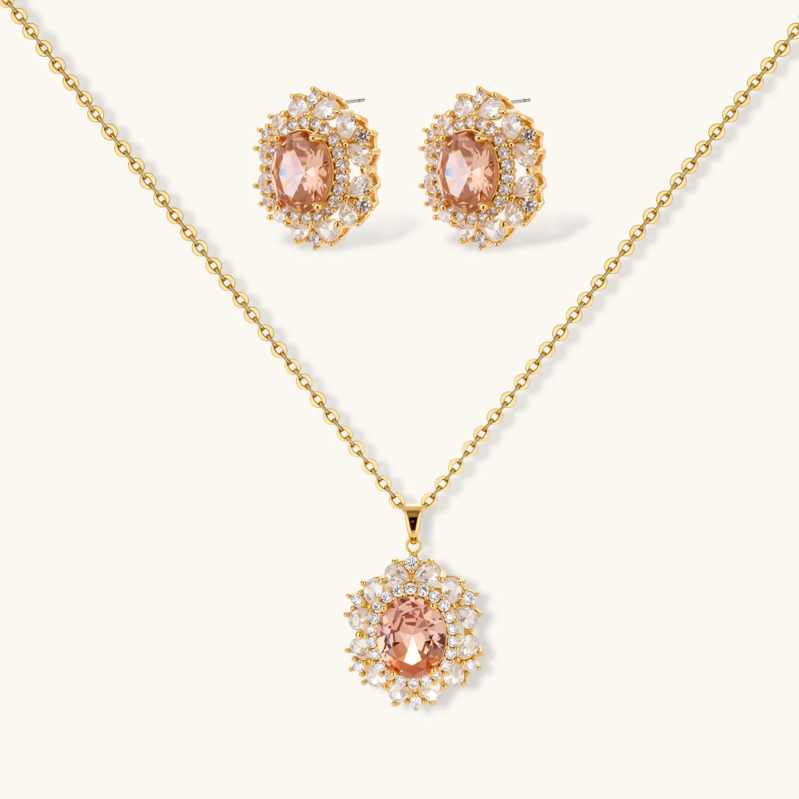 Ornate gold-plated jewelry set featuring peach center stone surrounded by clear AAA cubic zirconia crystals