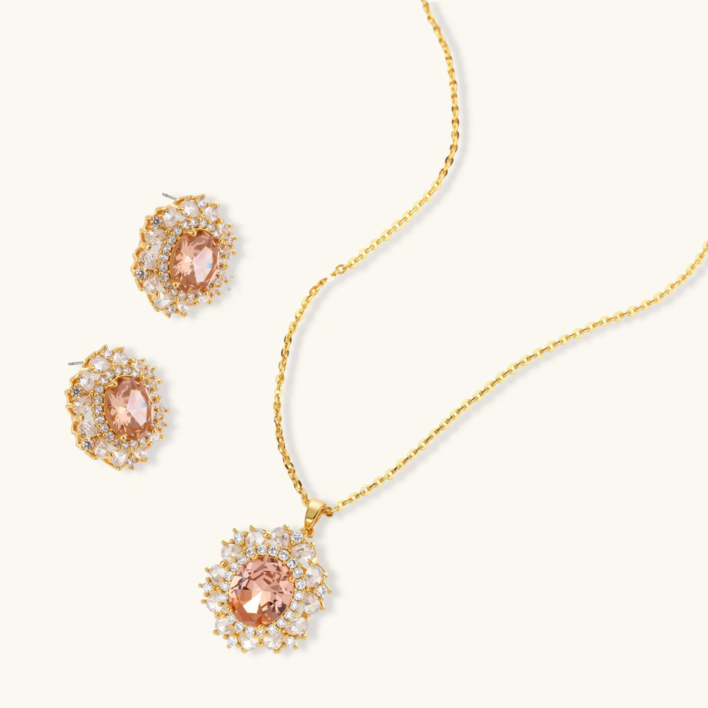 Ornate gold-plated jewelry set featuring peach center stone surrounded by clear AAA cubic zirconia crystals