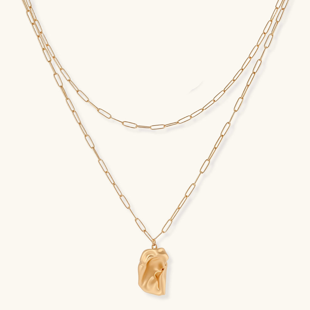 Layered paperclip chain necklace with organic flowing pendant made from eco-zinc alloy in warm gold finish