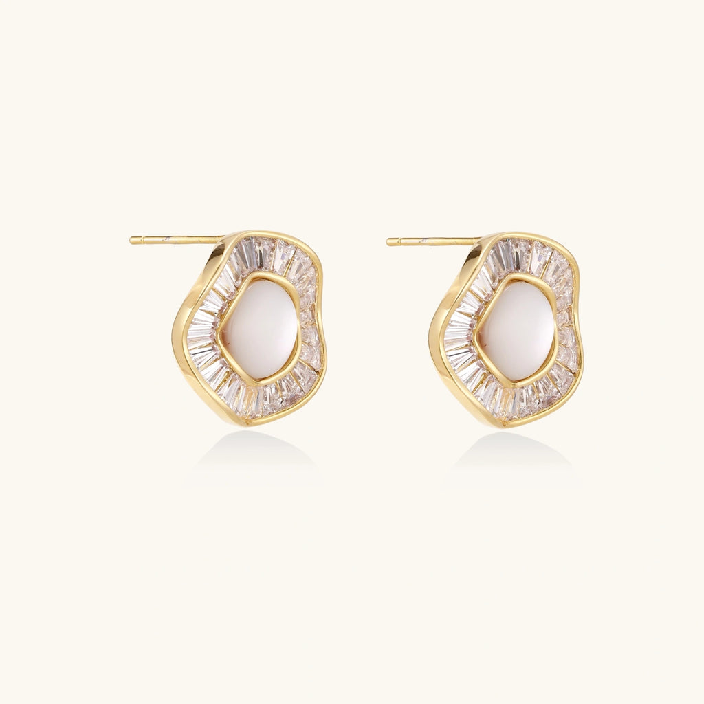 Gold-plated stud earrings with central freshwater pearl surrounded by radiating baguette crystals in sunburst design