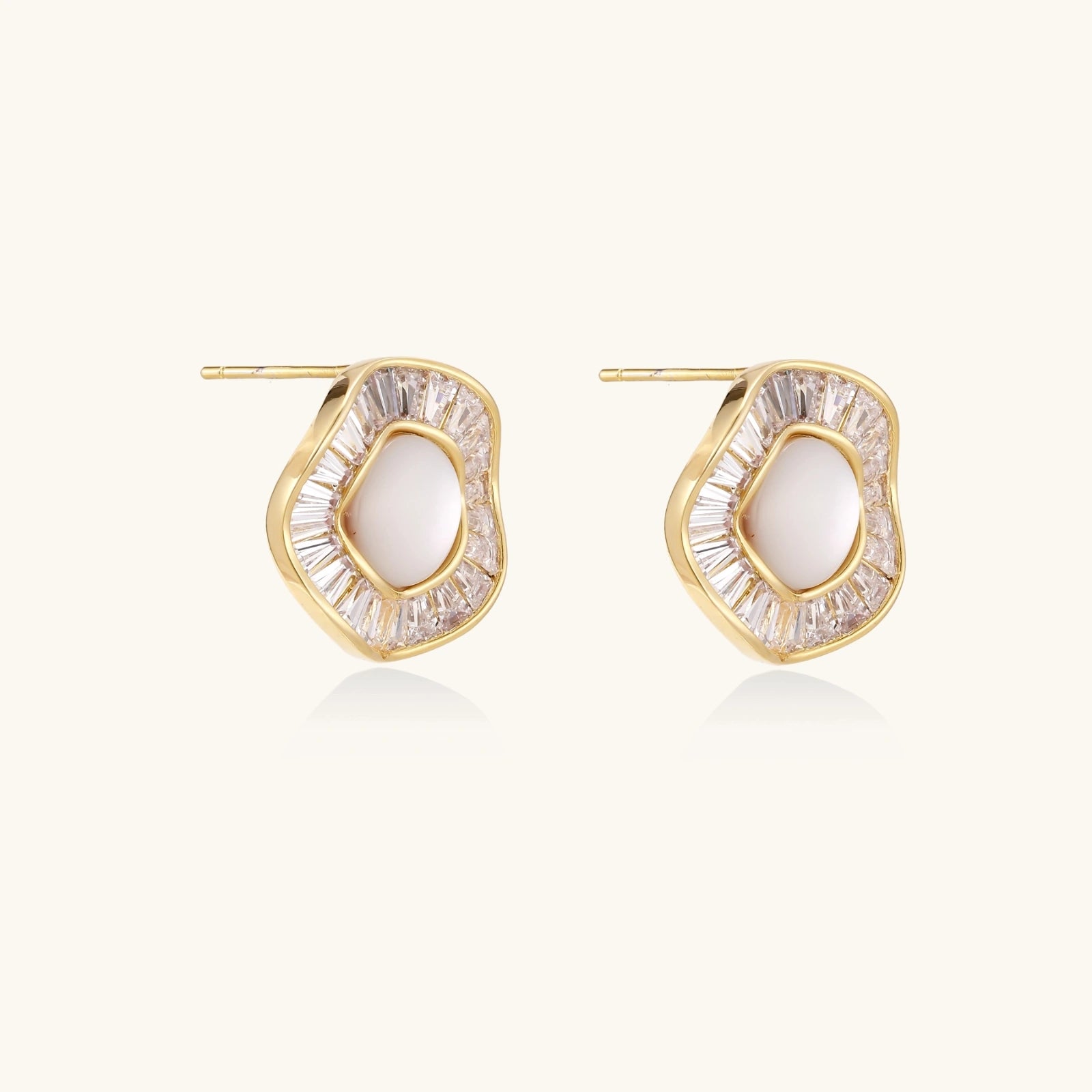 Gold-plated stud earrings with central freshwater pearl surrounded by radiating baguette crystals in sunburst design