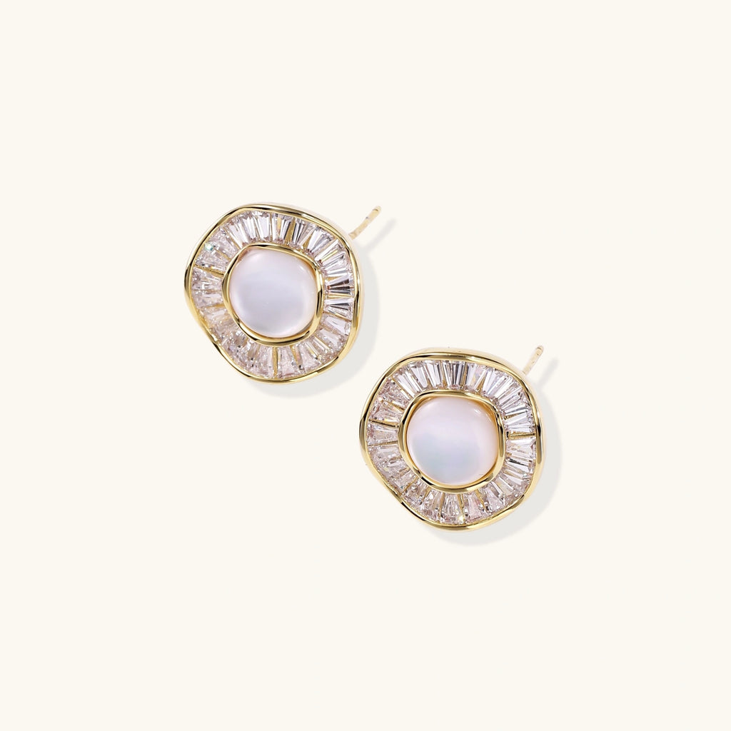 Gold-plated stud earrings with central freshwater pearl surrounded by radiating baguette crystals in sunburst design