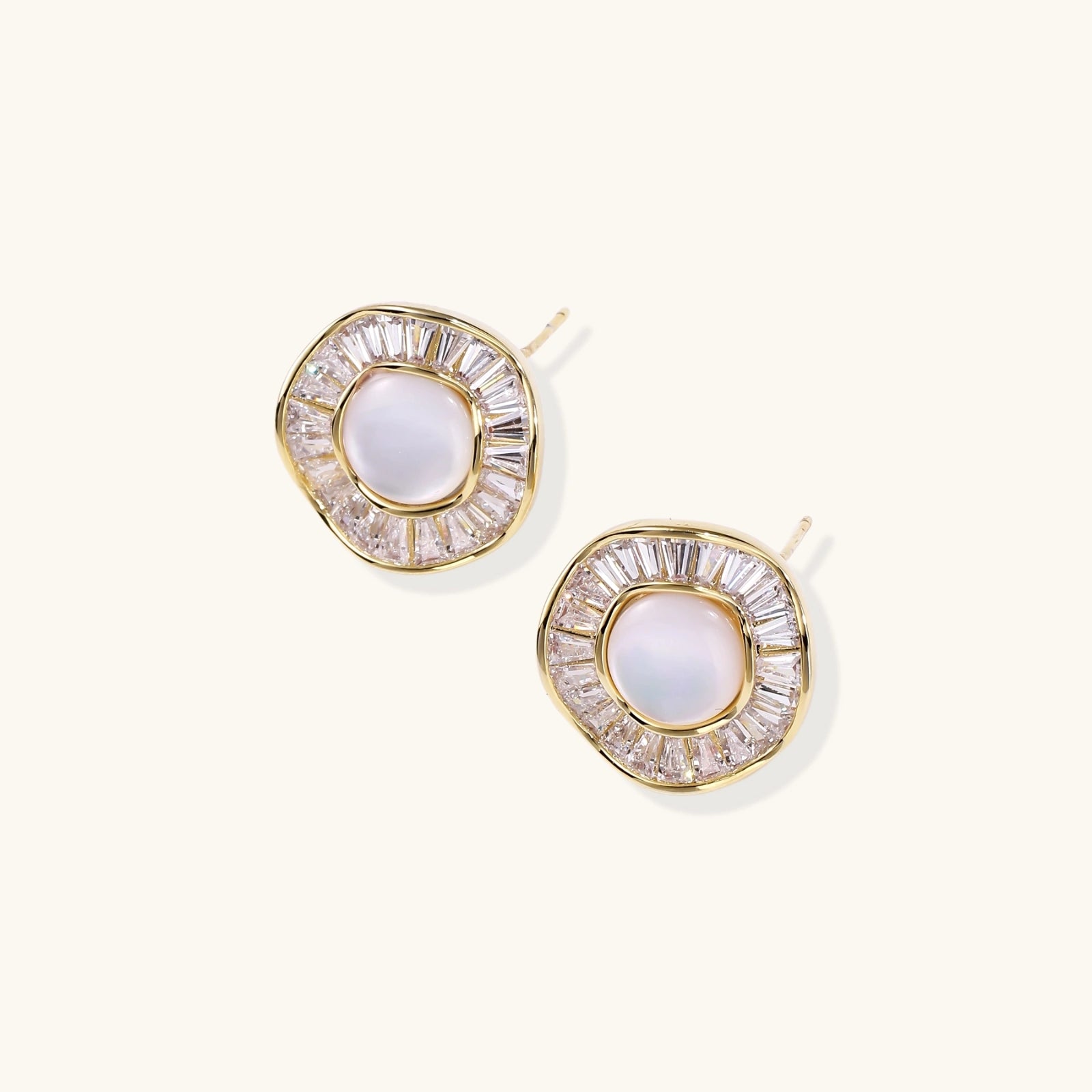 Gold-plated stud earrings with central freshwater pearl surrounded by radiating baguette crystals in sunburst design