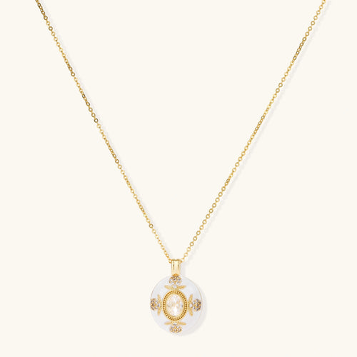 Gold-plated necklace with circular white enamel pendant featuring central zirconia stone and ornate decorative details