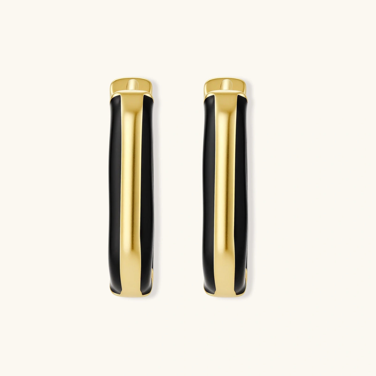 Modern hoop earrings with gold-plated and black sections, featuring hinged closure on white background.