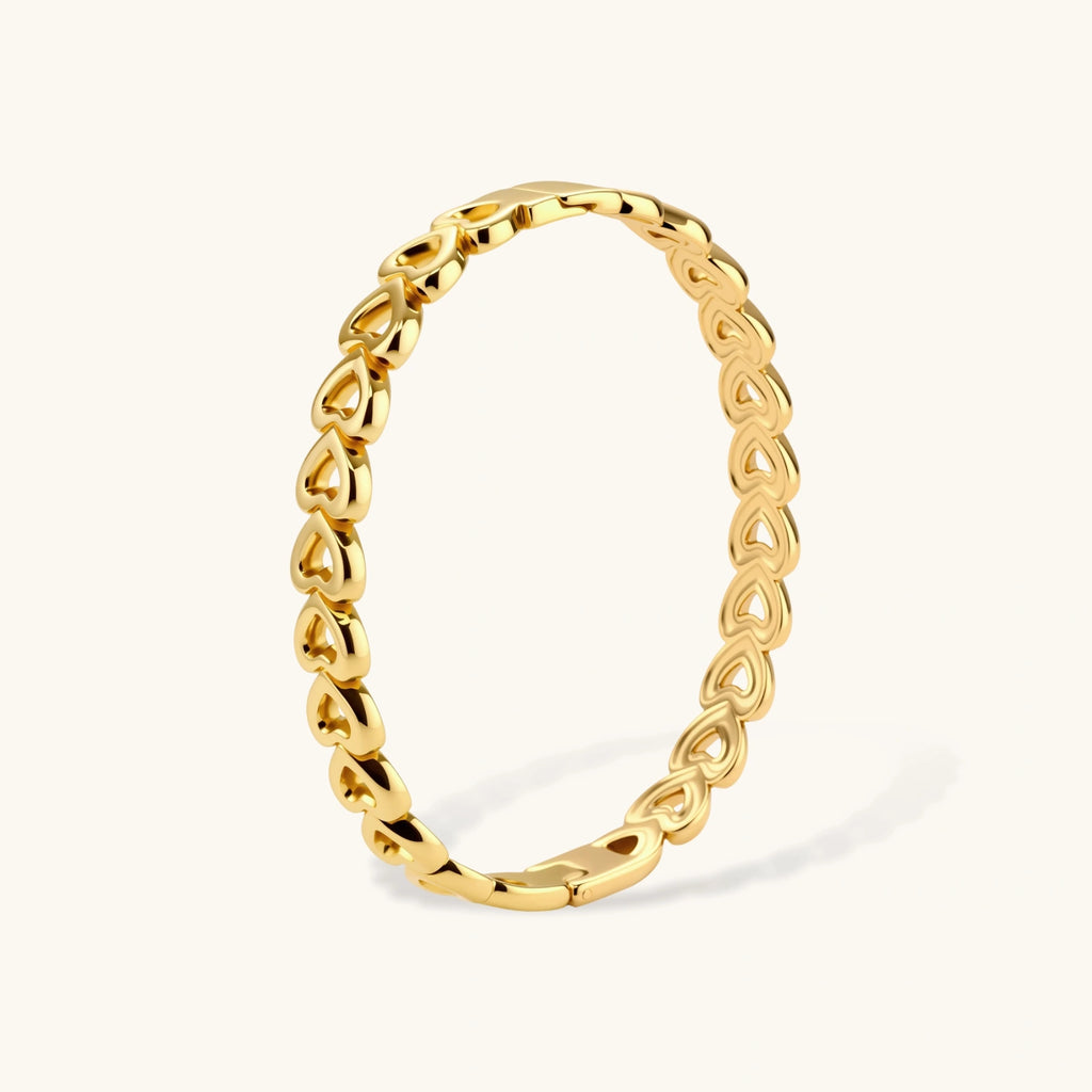 Gold 18K plated stainless steel bangle with continuous open heart links, high-polish finish, on white background.