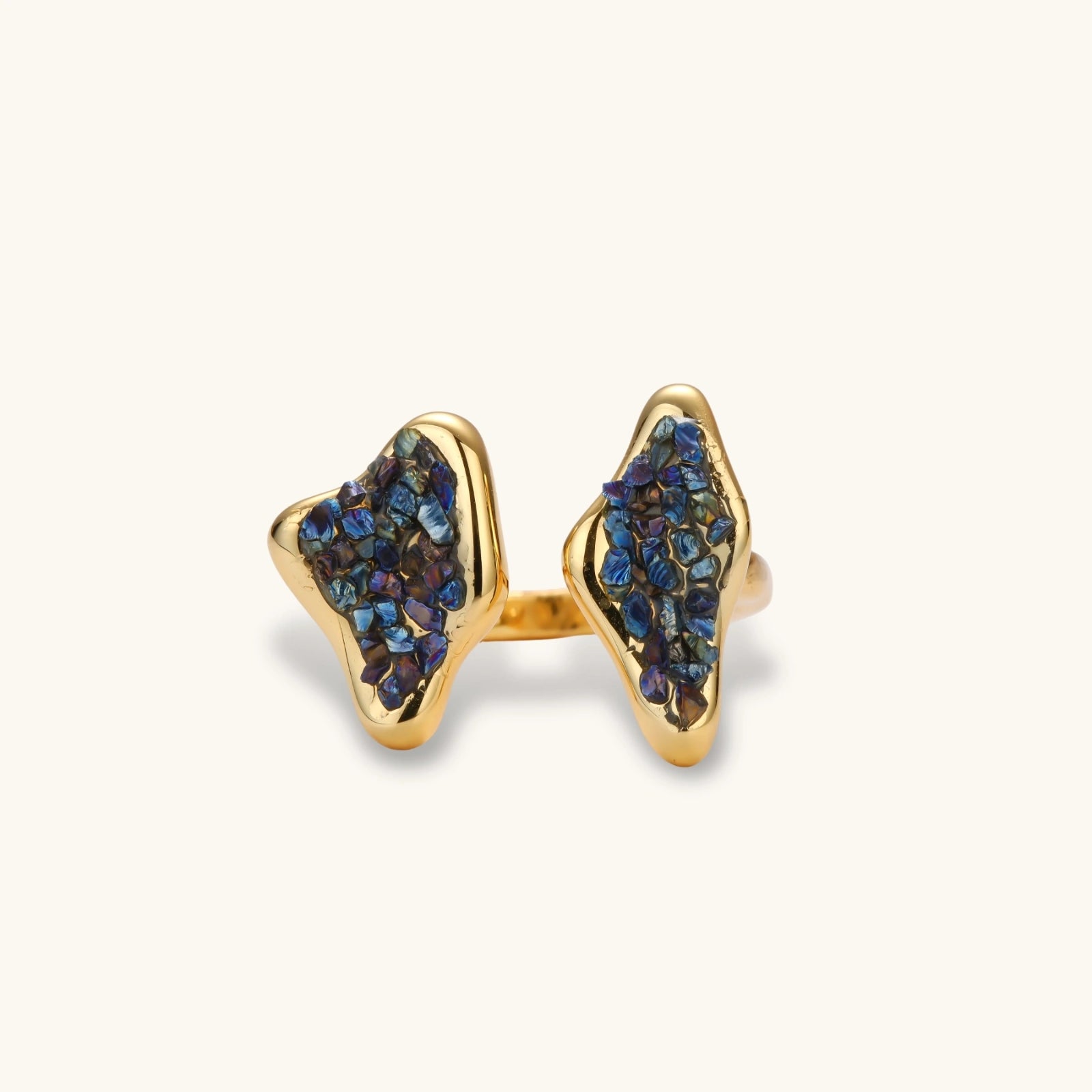 Adjustable gold-plated open cuff ring featuring clustered blue natural stones at each end on neutral background.