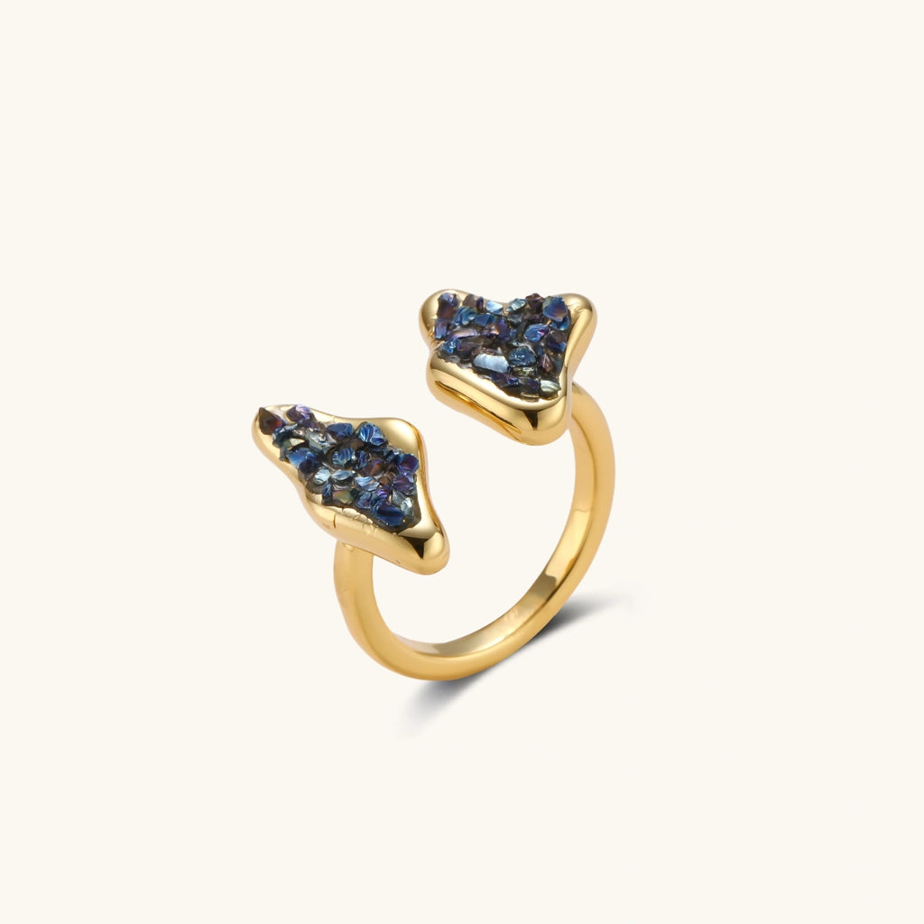 Adjustable gold-plated open cuff ring featuring clustered blue natural stones at each end on neutral background.